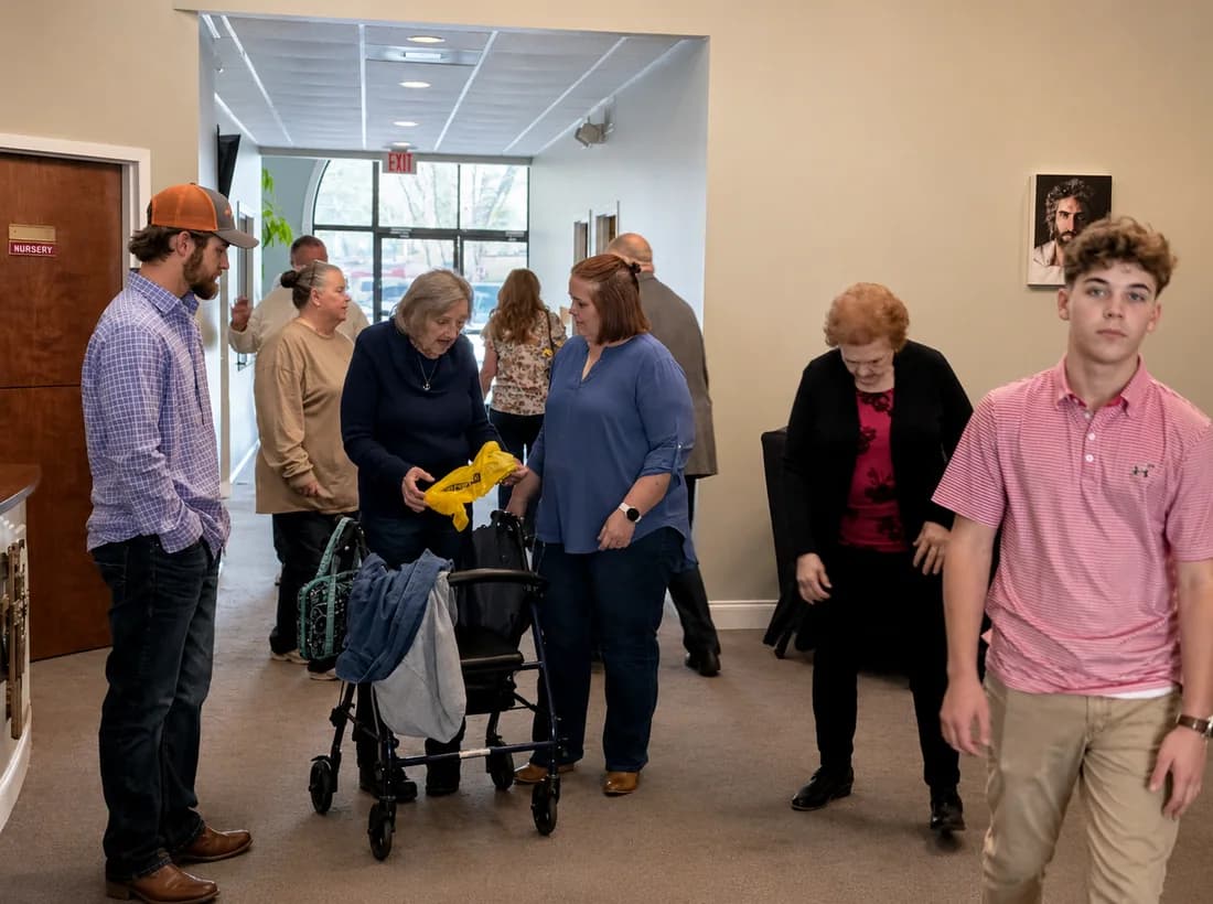 PCAG members welcoming one another in the church lobby